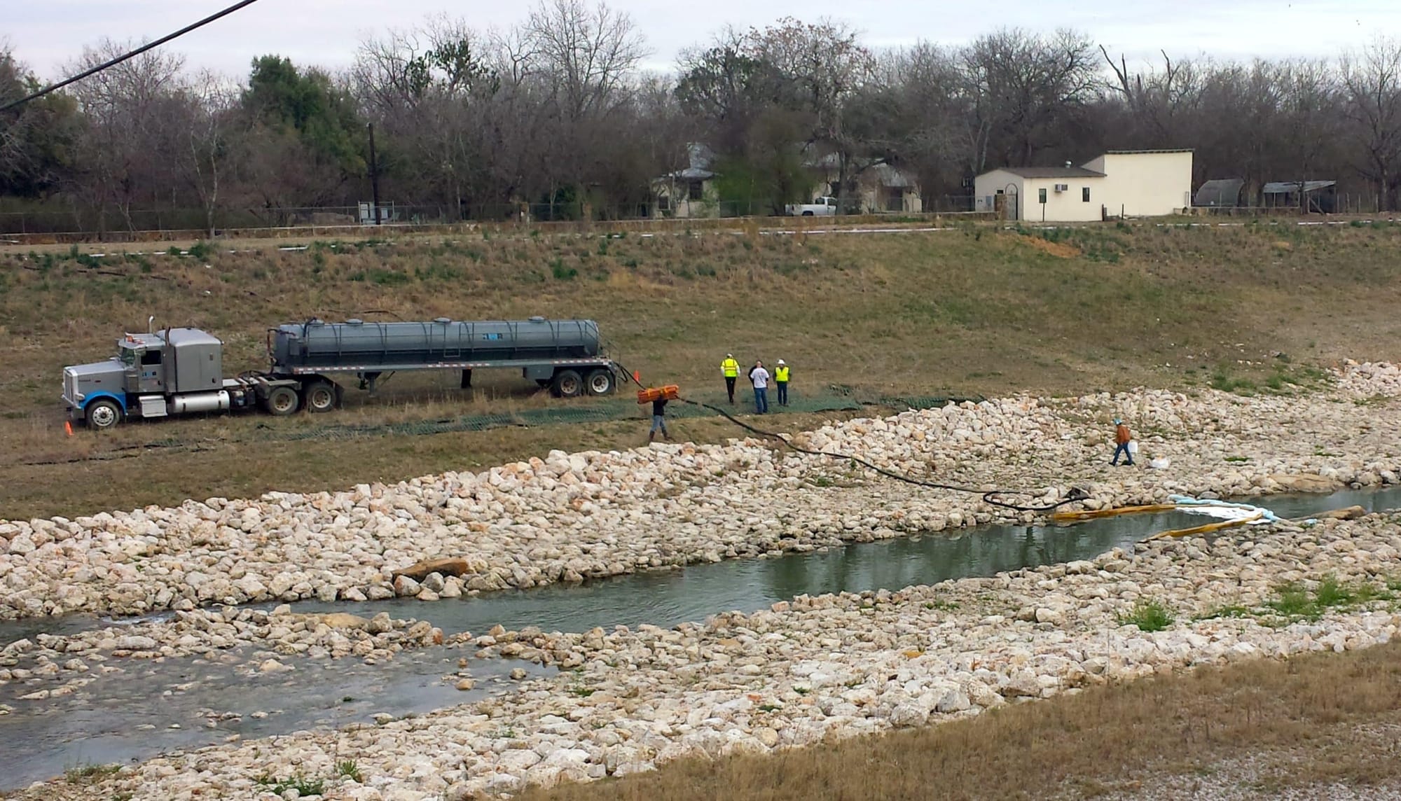 A vacuum truck being used to remove spilled fuel from the San Antonio River earlier this year.