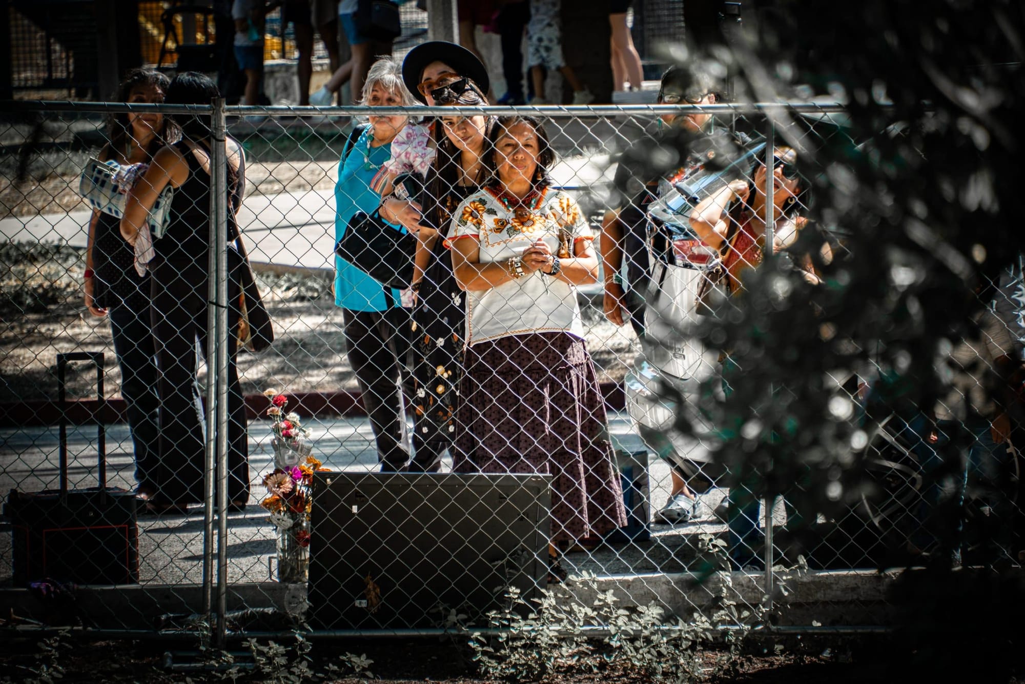 Attendees at last weekend's Indigenous Peoples Day gathering at Brackenridge Park send their prayers toward the river during a water ceremony. 