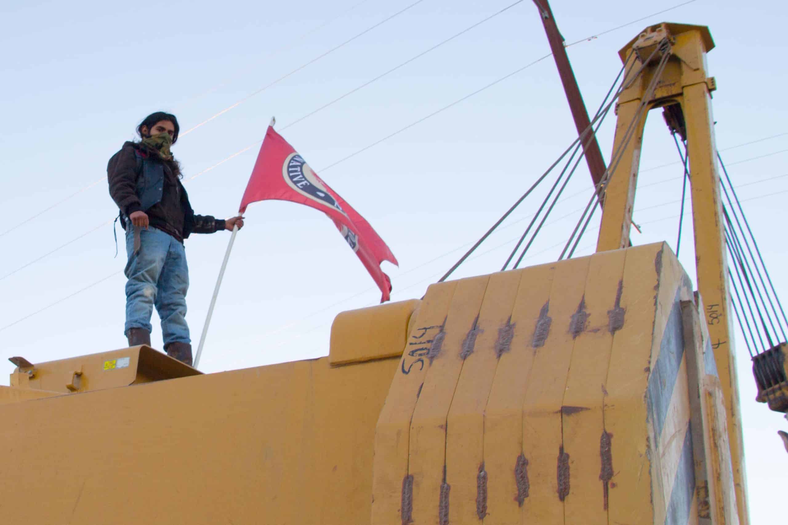 A water protector atop excavation equipment in Presidio County, Texas, last weekend.